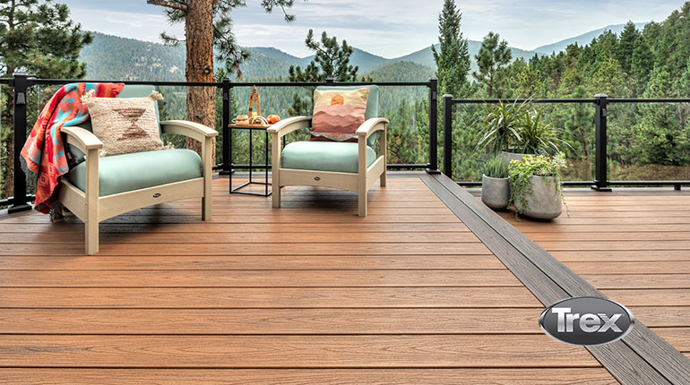 Beautiful Trex Composite Decking installed with glass railings, overlooking a scenic view